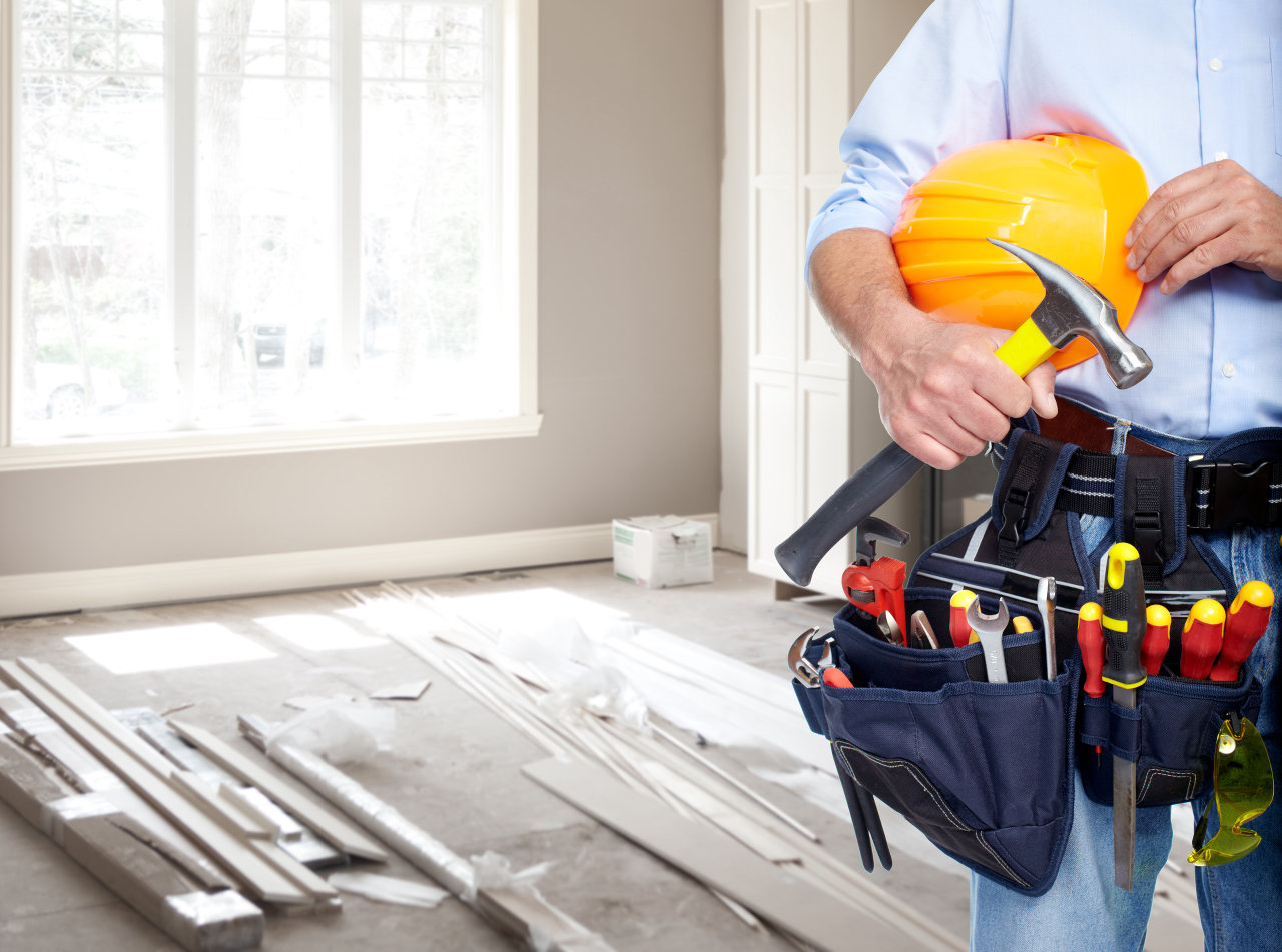 Handyman with a tool belt. House renovation service.